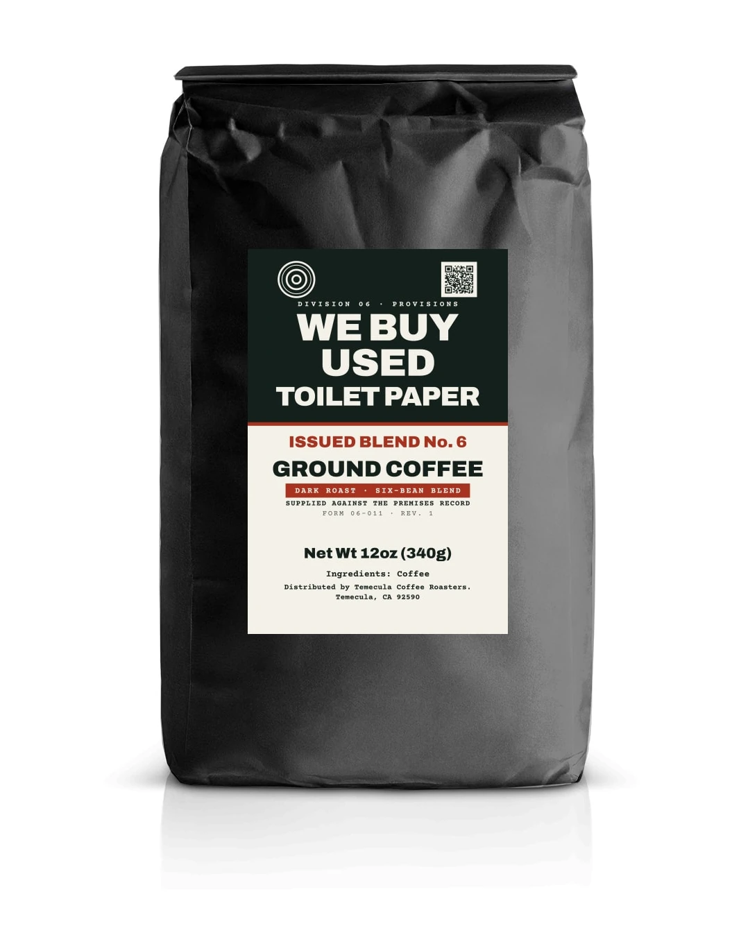 A black stand-up coffee pouch carrying the Issued Blend No. 6 label: the office mark and Division 06 above the words WE BUY USED TOILET PAPER, then GROUND COFFEE, dark roast, six-bean blend, net weight 12 oz.